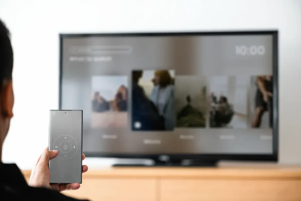 man-changing-tv-channel-by-his-smartphone