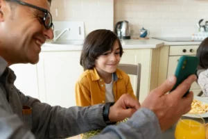 father-son-looking-smartphone-home