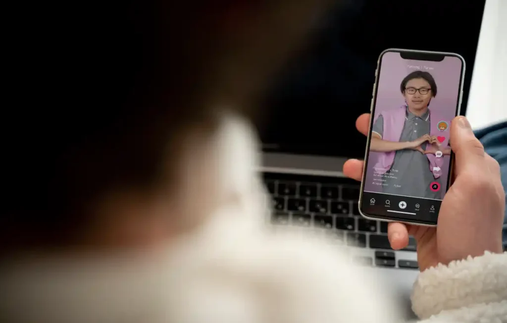 teenager-watching-video-using-his-smartphone-while-sitting-his-bed