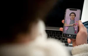 teenager-watching-video-using-his-smartphone-while-sitting-his-bed