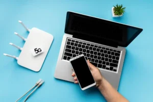 top-view-wi-fi-router-with-laptop-hand-holding-smartphone